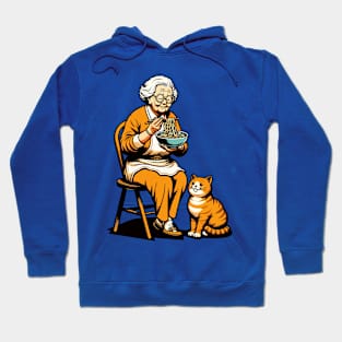 Grandma sitting on a chair with a cat, both enjoying noodles Hoodie